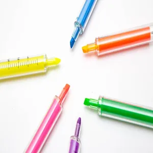 Close-up of six vibrant syringe-shaped highlighters in a colorful circular arrangement