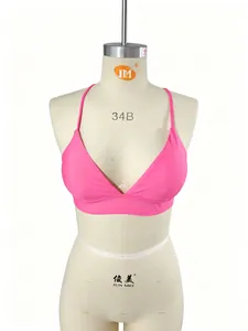 Vibrant neon pink sports bikini top with thin straps displayed on a mannequin