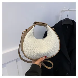 Modern white woven crescent shoulder bag for women with stylish khaki trim and strap