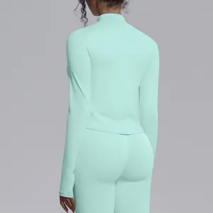 Back view of women's seamless mint green slim-fit yoga jacket and athletic leggings.