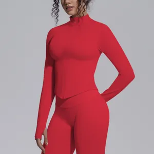 Detailed view of red seamless zipper athletic top with stand collar and thumb holes