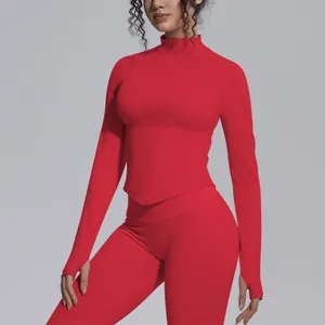 Detailed close-up of a red seamless yoga jacket featuring a stand collar and thumbholes