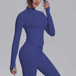 Vibrant blue high-stretch seamless yoga top with a mock neck and thumbhole sleeves.