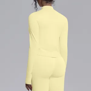 Detailed back view of a seamless high-stretch long sleeve yoga top in light yellow color