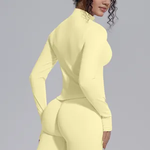 Close-up detail of seamless high-stretch yoga jacket with stand collar in pale yellow color