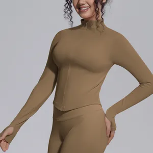 Close-up detail of women's seamless athletic jacket with stand collar and zipper in khaki