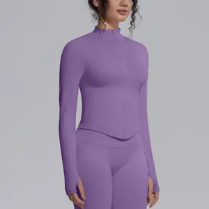 Close-up of a seamless purple yoga jacket with mock neck zipper and thumbholes detail