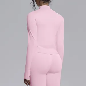 Rear view of a pink seamless high-stretch athletic yoga top with a high collar for women