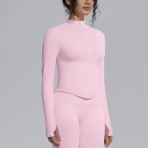 Close-up of pink seamless yoga jacket featuring stand collar and zipper detail.