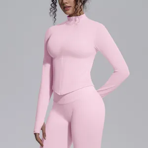 Pink seamless yoga jacket with high neck zipper and functional thumb hole design