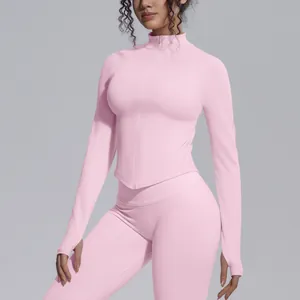 Detail view of a pink seamless breathable yoga jacket with a stand collar and zipper.