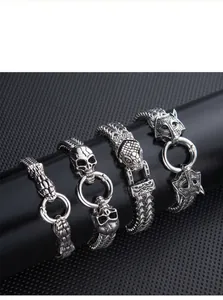 Close-up of gothic punk bracelets featuring snake, skull, and wolf head stainless steel designs.