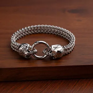 Vintage punk style stainless steel men's bracelet featuring dual skull heads design