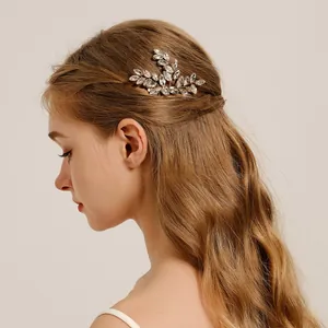 Side view of a bride wearing an elegant rhinestone leaf hair comb for wedding