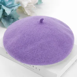 Close-up of a purple wool beret featuring soft felt texture and classic bud top design.