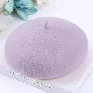 Close-up detail of a soft purple wool beret showing premium felt texture and stem.