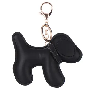 Close-up detail of a puffy black leather puppy keychain with rose gold hardware