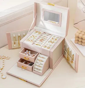 Pink multi-layer jewelry box organizer showing open drawers and interior compartments