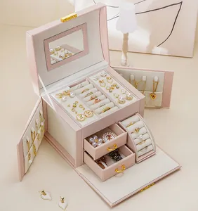 Detailed interior view of a pink multi-layer jewelry organizer box with drawers