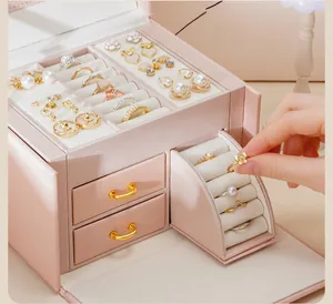 Detailed close-up of a pink multi-layer jewelry box with rotating ring storage drawers