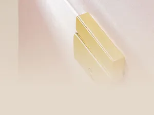 Macro detail view of premium gold metal clasp on pink textured fabric jewelry storage box