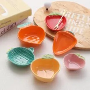 Set of creative fruit-shaped ceramic bowls including strawberry and carrot designs.