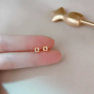 Minimalist gold geometric square stud earrings with micro diamond accents for women.