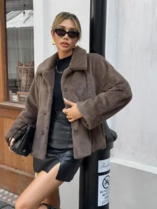 Chic woman wearing a brown faux fur jacket and black leather skirt in an urban setting.