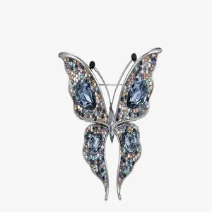 A detailed view of the sparkling crystal-inlaid butterfly brooch accessory for suits.