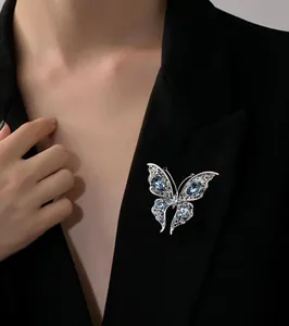 Detailed view of an exquisite crystal butterfly brooch pinned on a black blazer lapel.