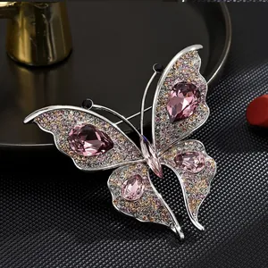 Elegant butterfly brooch featuring pink pear-shaped crystals and shimmering rhinestones