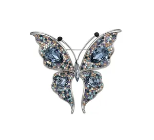 Macro detail of an exquisite crystal butterfly brooch with shimmering blue gems and alloy frame