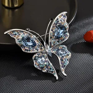 Exquisite silver-tone crystal butterfly brooch featuring gradient blue teardrop stones