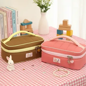 Cute large-capacity quilted cosmetic bags in pink and brown with top handles and charms