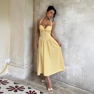 Elegant yellow halter neck dress with bow and corset bodice for formal evening events.