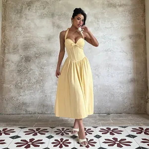 Elegant yellow halter neck midi dress with bow detail and corset-style A-line skirt.