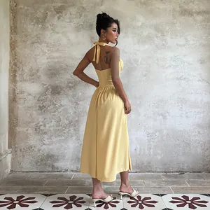 Elegant yellow halter neck A-line evening maxi dress featuring bow tie and open back design