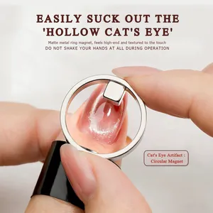 Close-up of circular ring magnet creating hollow cat's eye effect on pink nails