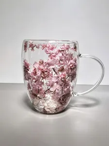 Detailed macro view of heat-resistant double-walled glass mug filled with pink dried flowers