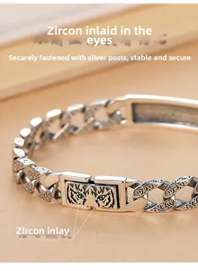 Detailed macro view of silver tiger totem bracelet featuring green zircon stone eyes