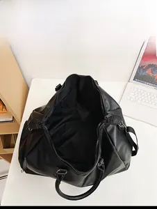 Detailed interior view of a black PU travel bag showing spacious capacity and lining