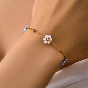 Elegant 18k gold plated chain bracelet with pearl flower and purple beads on female wrist