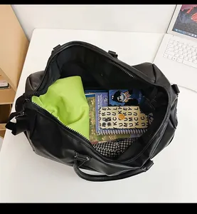 Detailed interior view of a black PU travel bag showing large capacity for essentials