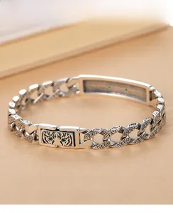Close-up of sterling silver tiger totem bracelet with intricate Tang grass engravings