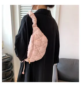 Close-up view of pink quilted cloud bag showing soft puff texture and drawstring strap