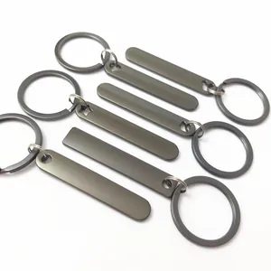 Detailed macro view of five blank gunmetal rectangular bar keychains for custom engraving