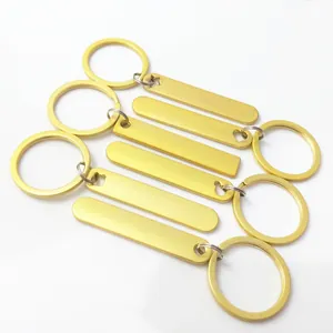 Detailed close-up showing five blank golden metal keychains ideal for custom engraving