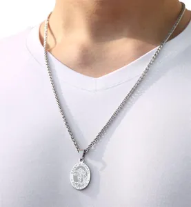 Close-up of religious Saint Michael medal pendant on stainless steel wheat chain necklace