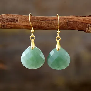 Elegant teardrop-shaped green natural stone dangle earrings with gold hooks on wood