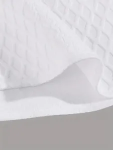 Macro detail of white jacquard knitted fabric on a men's casual short sleeve shirt